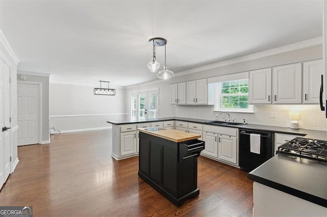 3544 Chestatee Dr, Marietta, GA 30062 - kitchen featuring dishwasher, a sink, crown molding, a peninsula, and butcher block counters