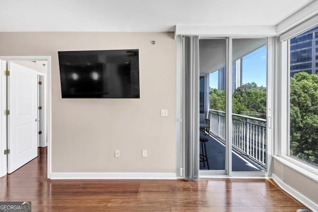 3338 Peachtree Rd NE Unit 508, Atlanta, GA 30326 - unfurnished living room with wood finished floors and baseboards
