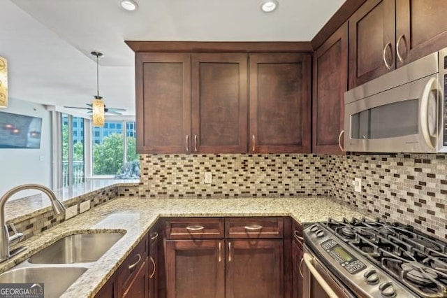 3338 Peachtree Rd NE Unit 508, Atlanta, GA 30326 - kitchen featuring stainless steel appliances, a sink, tasteful backsplash, light stone counters, and dark brown cabinets