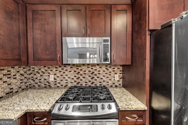3338 Peachtree Rd NE Unit 508, Atlanta, GA 30326 - kitchen featuring appliances with stainless steel finishes, tasteful backsplash, and light stone counters
