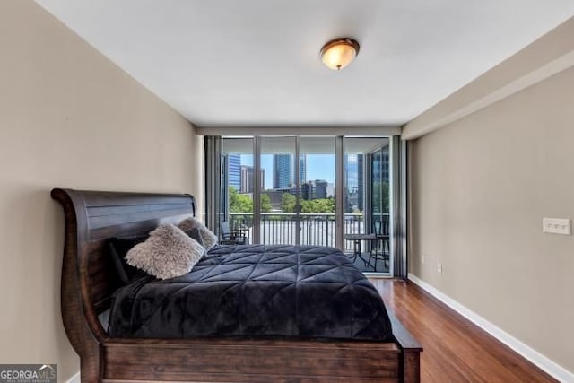 3338 Peachtree Rd NE Unit 508, Atlanta, GA 30326 - bedroom with access to exterior, wood finished floors, baseboards, expansive windows, and a city view