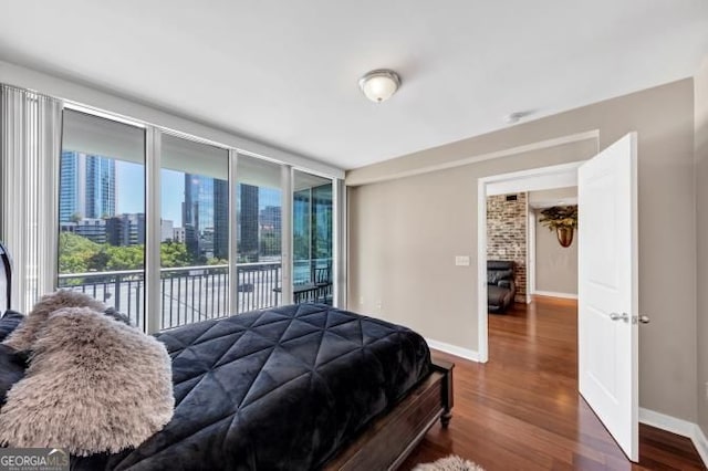 3338 Peachtree Rd NE Unit 508, Atlanta, GA 30326 - bedroom with access to outside, dark wood finished floors, baseboards, and a view of city