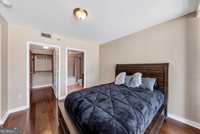 3338 Peachtree Rd NE Unit 508, Atlanta, GA 30326 - bedroom featuring wood finished floors, baseboards, and connected bathroom