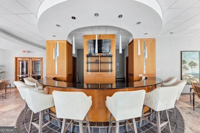 3338 Peachtree Rd NE Unit 508, Atlanta, GA 30326 - bar featuring hanging light fixtures and a drop ceiling