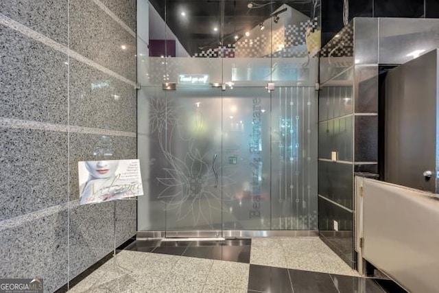 3338 Peachtree Rd NE Unit 508, Atlanta, GA 30326 - bathroom featuring granite tiled floors and a shower with shower door