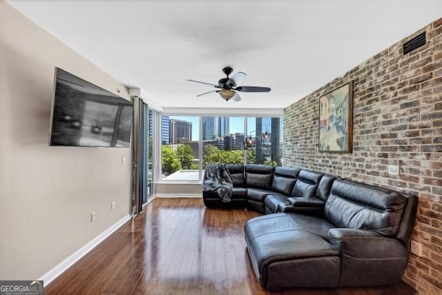 3338 Peachtree Rd NE Unit 508, Atlanta, GA 30326 - living area with baseboards, ceiling fan, hardwood / wood-style floors, and brick wall