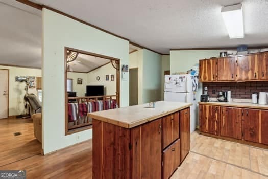 4369 River Rd, Folkston, GA 31537 - kitchen with light wood-type flooring, brown cabinets, and light countertops