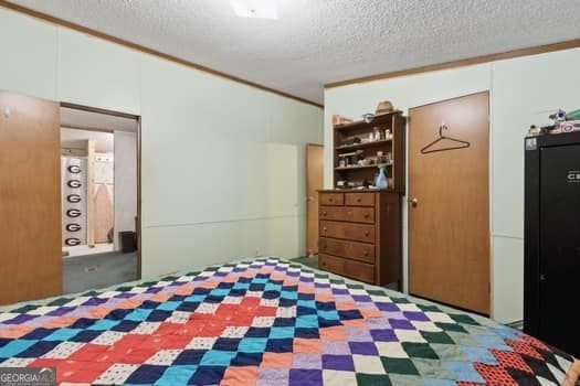 4369 River Rd, Folkston, GA 31537 - bedroom featuring a textured ceiling and ornamental molding