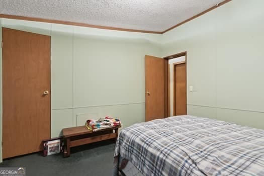 4369 River Rd, Folkston, GA 31537 - bedroom with carpet, a textured ceiling, and ornamental molding