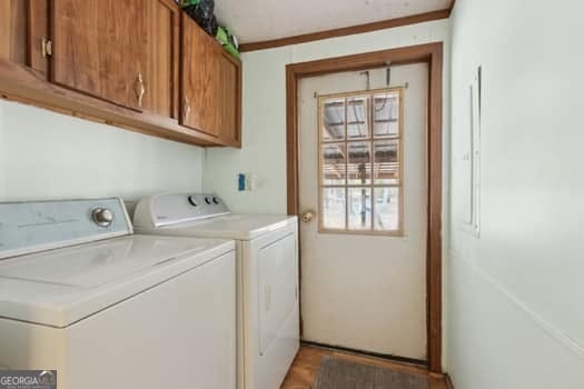 4369 River Rd, Folkston, GA 31537 - washroom featuring separate washer and dryer and cabinet space