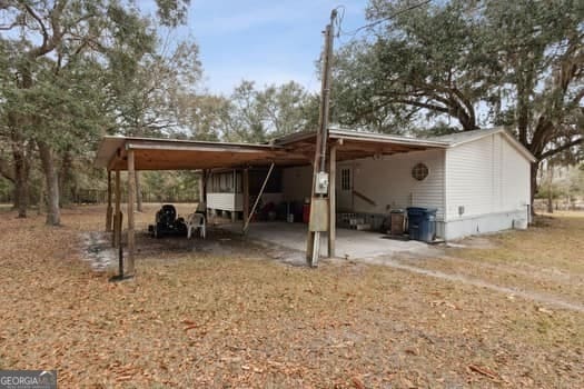 4369 River Rd, Folkston, GA 31537 - view of vehicle parking featuring an attached carport