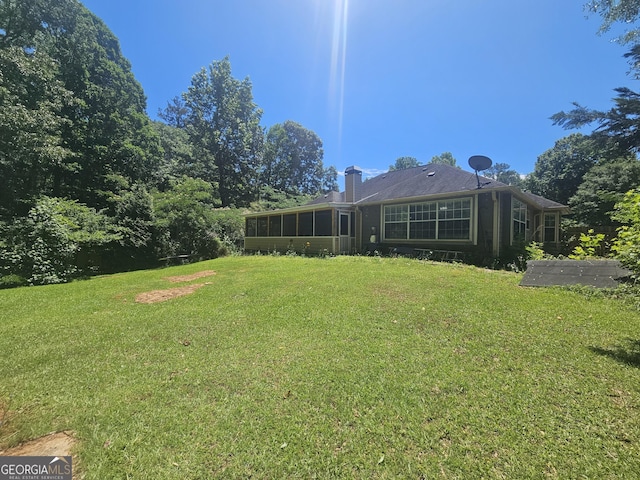212 Hunting Ct, Jonesboro, GA 30236 - view of grassy yard with a sunroom