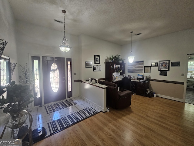 212 Hunting Ct, Jonesboro, GA 30236 - entrance foyer featuring a textured ceiling, wood finished floors, baseboards, and vaulted ceiling