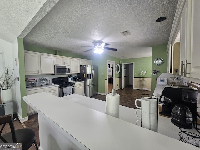 212 Hunting Ct, Jonesboro, GA 30236 - kitchen with stainless steel appliances, baseboards, white cabinets, light countertops, and ceiling fan