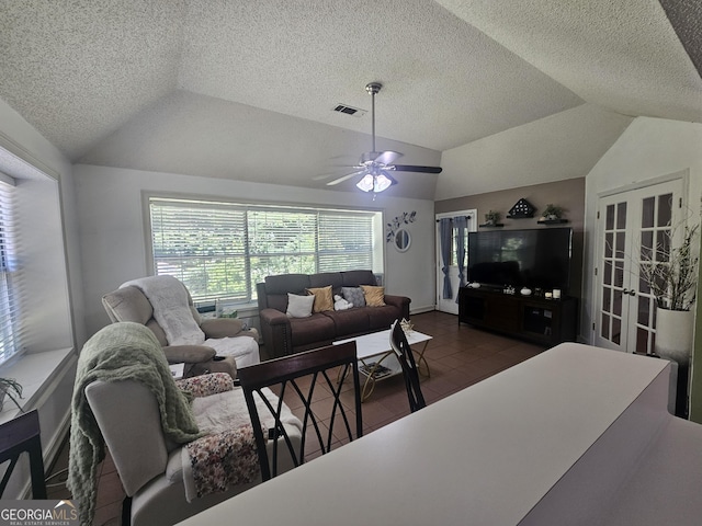 212 Hunting Ct, Jonesboro, GA 30236 - living room featuring lofted ceiling, french doors, a ceiling fan, a textured ceiling, and dark tile patterned floors