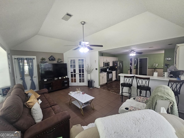 212 Hunting Ct, Jonesboro, GA 30236 - living room with ceiling fan, dark tile patterned flooring, vaulted ceiling, and french doors