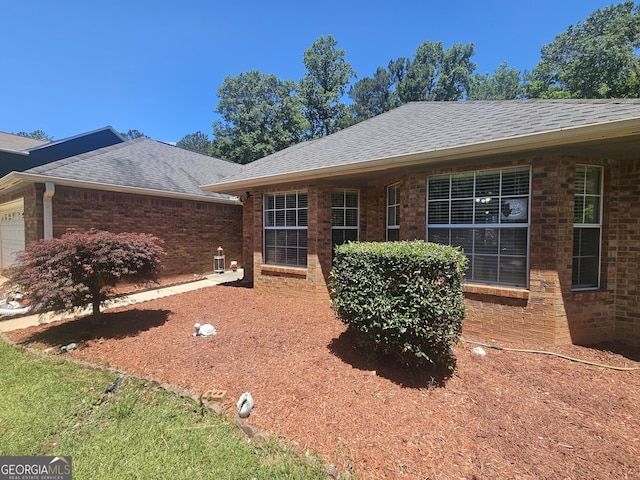 212 Hunting Ct, Jonesboro, GA 30236 - rear view of house with roof with shingles, a garage, and brick siding