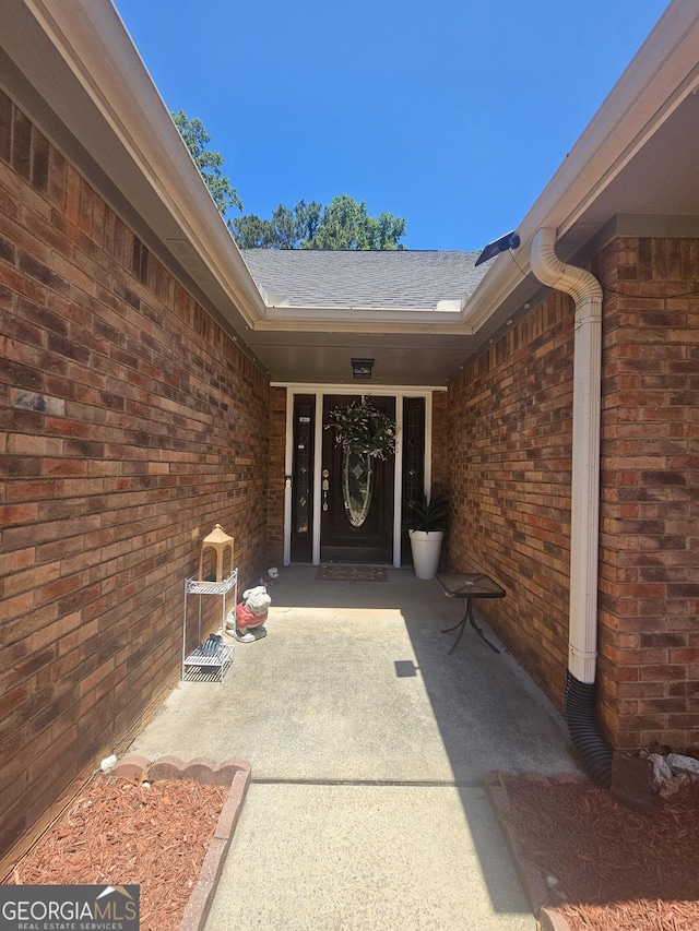 212 Hunting Ct, Jonesboro, GA 30236 - view of exterior entry with brick siding and roof with shingles