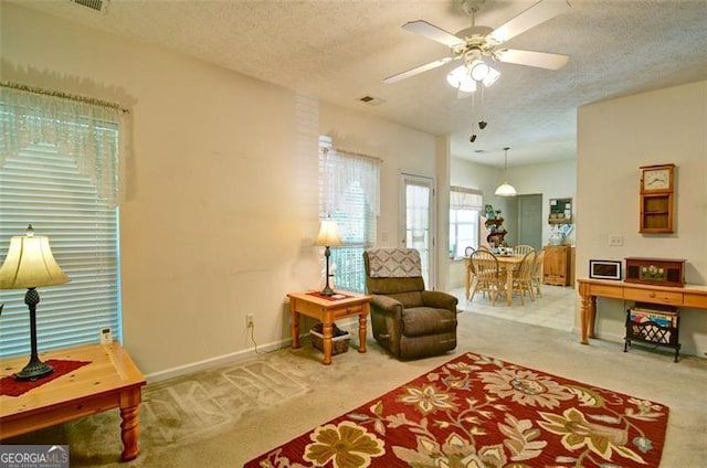 809 Longbranch Ln, Douglasville, GA 30134 - living area with carpet, a textured ceiling, a ceiling fan, and baseboards