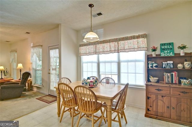 809 Longbranch Ln, Douglasville, GA 30134 - dining area with a textured ceiling, baseboards, and light floors