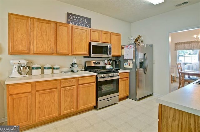 809 Longbranch Ln, Douglasville, GA 30134 - kitchen with stainless steel appliances, light flooring, light countertops, and a chandelier