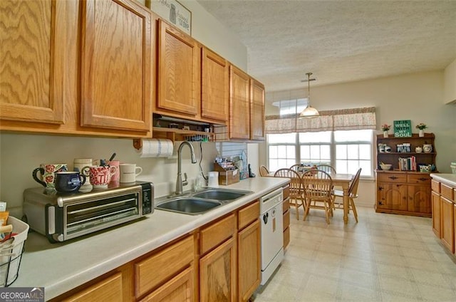 809 Longbranch Ln, Douglasville, GA 30134 - kitchen featuring a sink, white dishwasher, light countertops, a textured ceiling, and hanging light fixtures