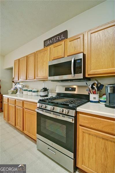 809 Longbranch Ln, Douglasville, GA 30134 - kitchen with appliances with stainless steel finishes, light countertops, and light floors