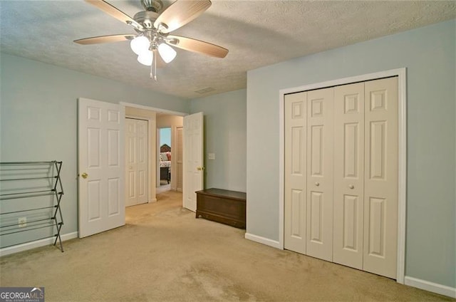 809 Longbranch Ln, Douglasville, GA 30134 - unfurnished bedroom with carpet, baseboards, a closet, a textured ceiling, and a ceiling fan