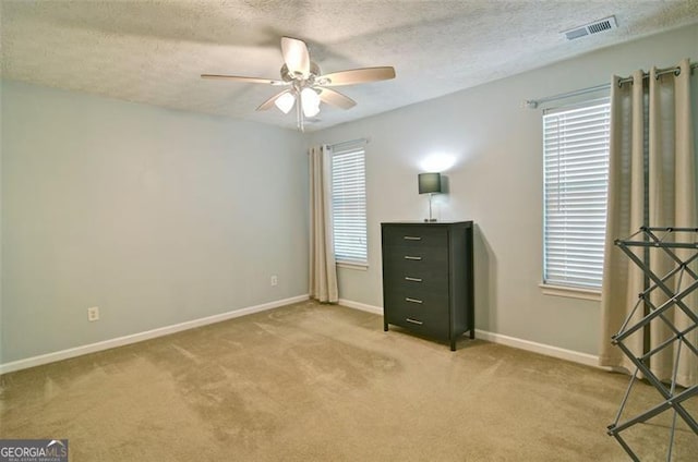 809 Longbranch Ln, Douglasville, GA 30134 - unfurnished bedroom with carpet flooring, multiple windows, baseboards, and a textured ceiling
