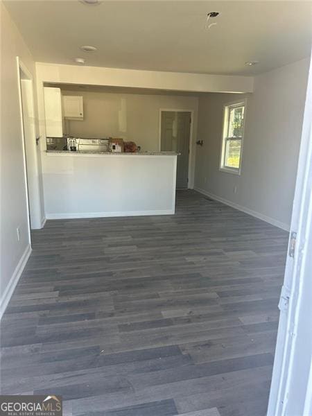 3005 Margaret Dr, Macon, GA 31206 - kitchen featuring baseboards, white cabinets, dark wood finished floors, and a peninsula