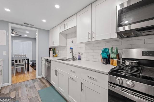 6851 Roswell Rd Unit E4, Sandy Springs, GA 30328 - kitchen with stainless steel appliances, a sink, light countertops, white cabinetry, and recessed lighting