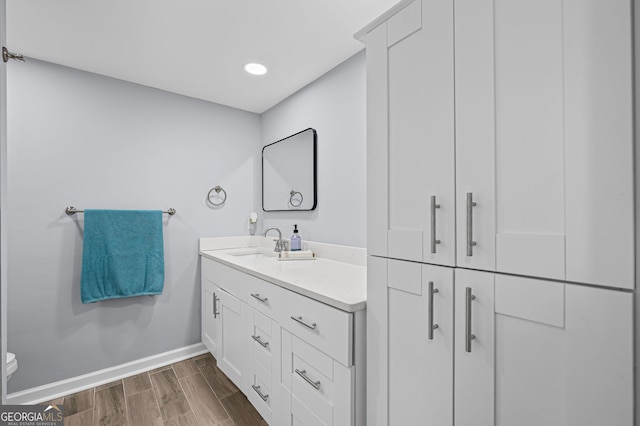 6851 Roswell Rd Unit E4, Sandy Springs, GA 30328 - bathroom featuring vanity, baseboards, wood finished floors, toilet, and recessed lighting