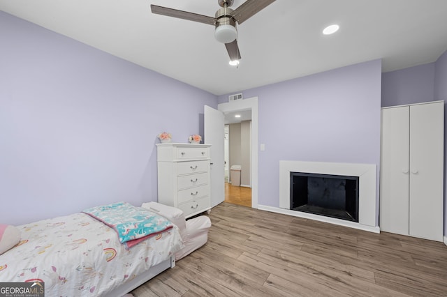 6851 Roswell Rd Unit E4, Sandy Springs, GA 30328 - bedroom with wood finished floors, a closet, ceiling fan, a fireplace, and recessed lighting