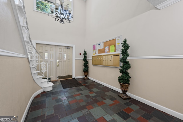 6851 Roswell Rd Unit E4, Sandy Springs, GA 30328 - foyer featuring stone tile flooring, baseboards, a chandelier, stairway, and a high ceiling
