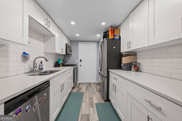 6851 Roswell Rd Unit E4, Sandy Springs, GA 30328 - kitchen with appliances with stainless steel finishes, a sink, white cabinetry, decorative backsplash, and recessed lighting