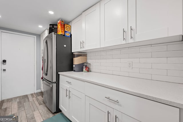 6851 Roswell Rd Unit E4, Sandy Springs, GA 30328 - kitchen featuring freestanding refrigerator, white cabinets, decorative backsplash, light wood-type flooring, and recessed lighting