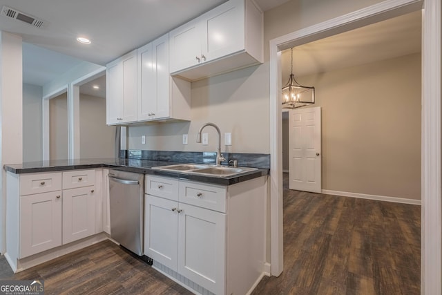 3107 Hendrix Cir SW, Covington, GA 30014 - kitchen featuring a sink, stainless steel dishwasher, dark wood finished floors, dark countertops, and recessed lighting