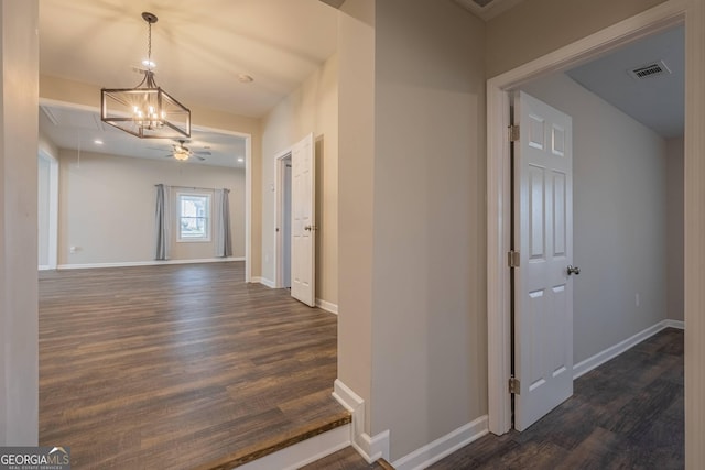 3107 Hendrix Cir SW, Covington, GA 30014 - corridor featuring attic access, dark wood-style floors, baseboards, a chandelier, and recessed lighting
