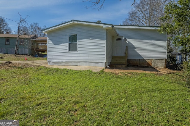 3107 Hendrix Cir SW, Covington, GA 30014 - rear view of property with entry steps and a yard