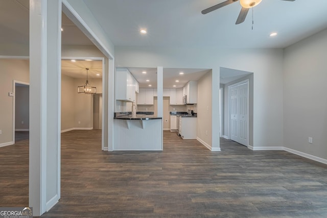3107 Hendrix Cir SW, Covington, GA 30014 - kitchen featuring dark countertops, open floor plan, baseboards, and recessed lighting