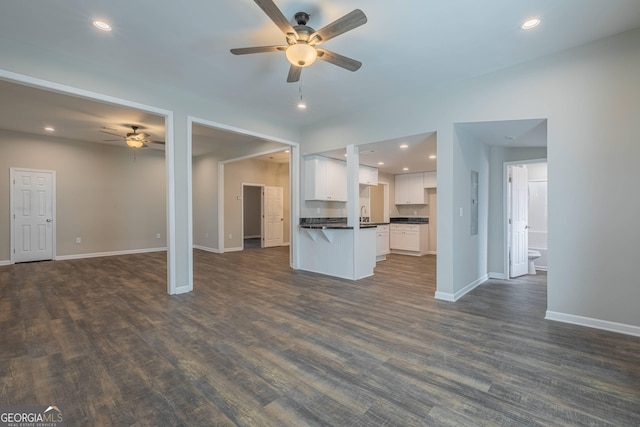 3107 Hendrix Cir SW, Covington, GA 30014 - unfurnished living room with ceiling fan, baseboards, dark wood-style flooring, a sink, and recessed lighting