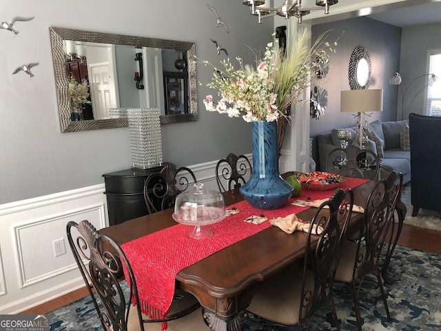 3692 Ramsey Cir, Atlanta, GA 30331 - dining space with wood finished floors, a chandelier, and a wainscoted wall