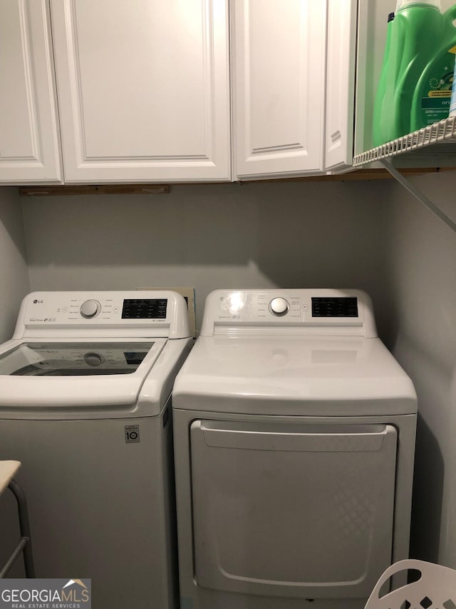 3692 Ramsey Cir, Atlanta, GA 30331 - laundry area featuring washer and clothes dryer and cabinet space