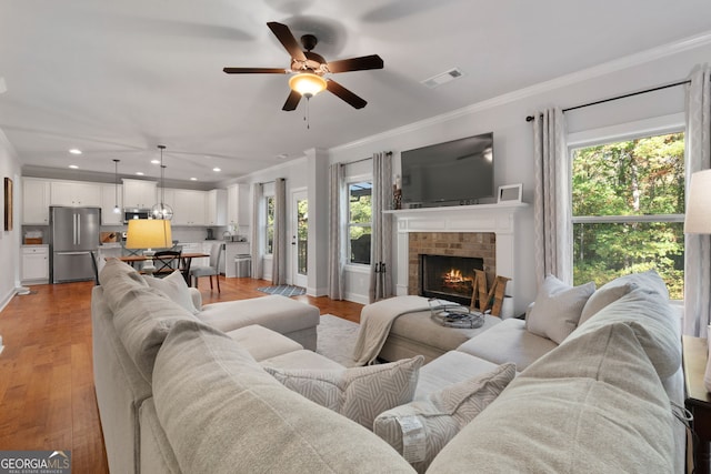 1412 Short Ct, Mcdonough, GA 30252 - living room with ornamental molding, healthy amount of natural light, a ceiling fan, recessed lighting, and a fireplace