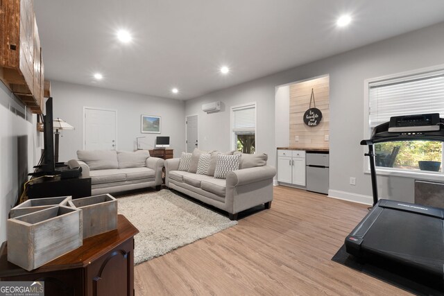 1412 Short Ct, Mcdonough, GA 30252 - living area with a wall mounted air conditioner, light wood finished floors, recessed lighting, and baseboards