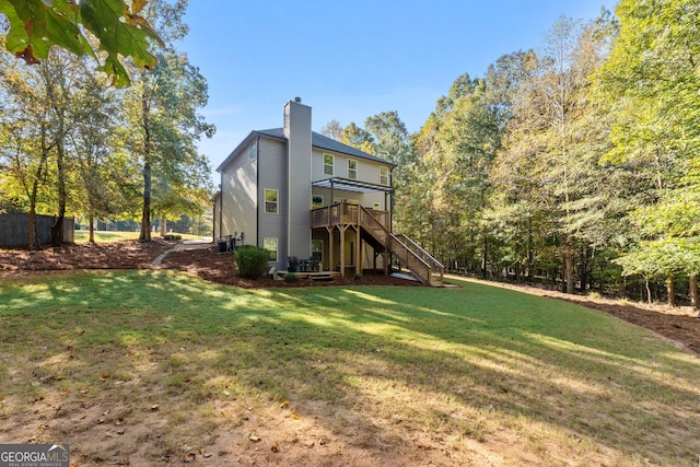 1412 Short Ct, Mcdonough, GA 30252 - rear view of property featuring stairway, a wooden deck, a lawn, and a chimney