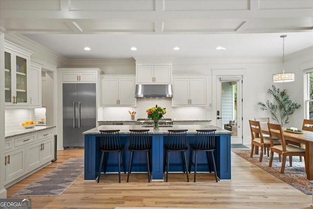 4048 Navajo Trl NE, Brookhaven, GA 30319 - kitchen with stainless steel built in fridge, under cabinet range hood, light wood finished floors, a kitchen bar, and backsplash