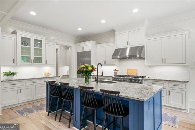 4048 Navajo Trl NE, Brookhaven, GA 30319 - kitchen with extractor fan, a sink, backsplash, white cabinets, and crown molding