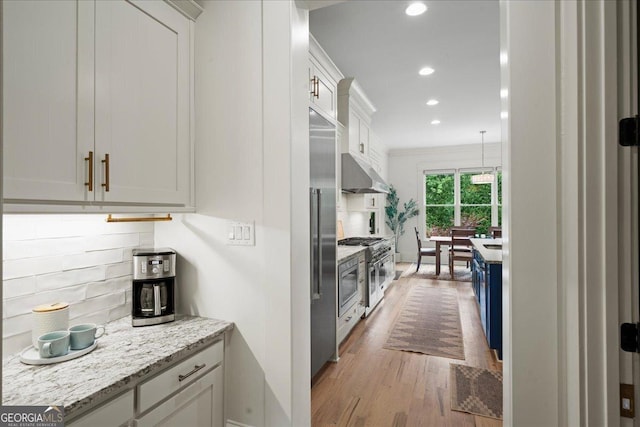 4048 Navajo Trl NE, Brookhaven, GA 30319 - kitchen with high quality appliances, under cabinet range hood, tasteful backsplash, wood finished floors, and recessed lighting