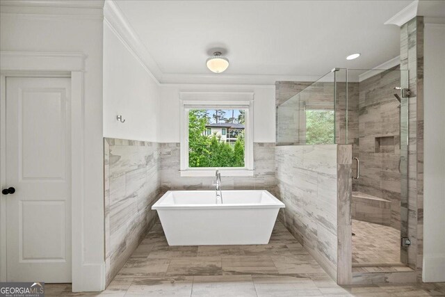 4048 Navajo Trl NE, Brookhaven, GA 30319 - full bath with crown molding, a freestanding tub, a shower stall, tile walls, and a wainscoted wall